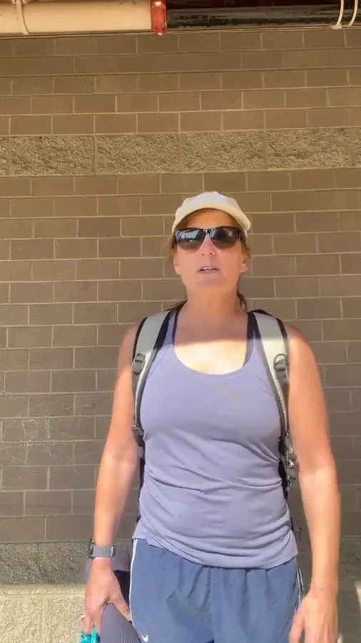 Fit member in her fifties with a yoga mat